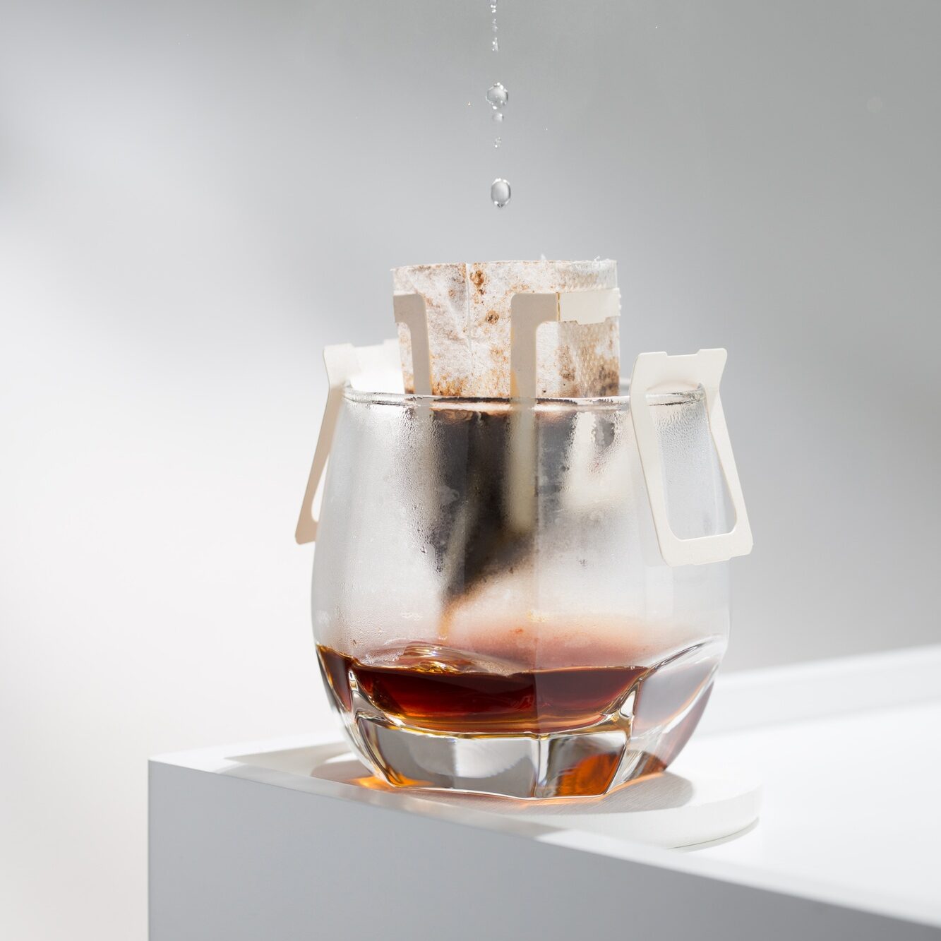 Drip bag brews coffee meticulously.